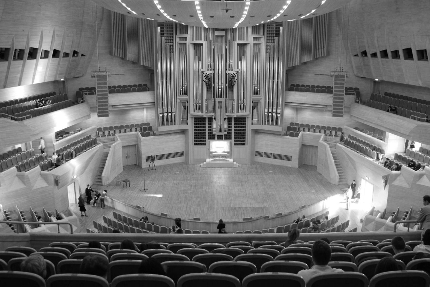 black and white photograph of large auditorium theater hall with pipe organ